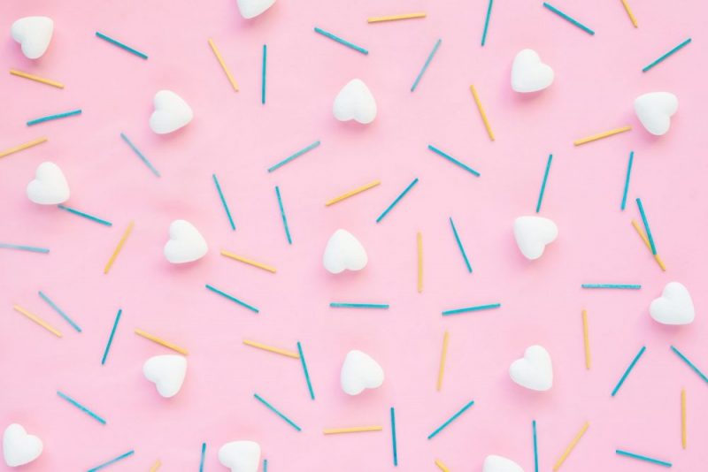 Valentines concept: hearts and sticks on pink background